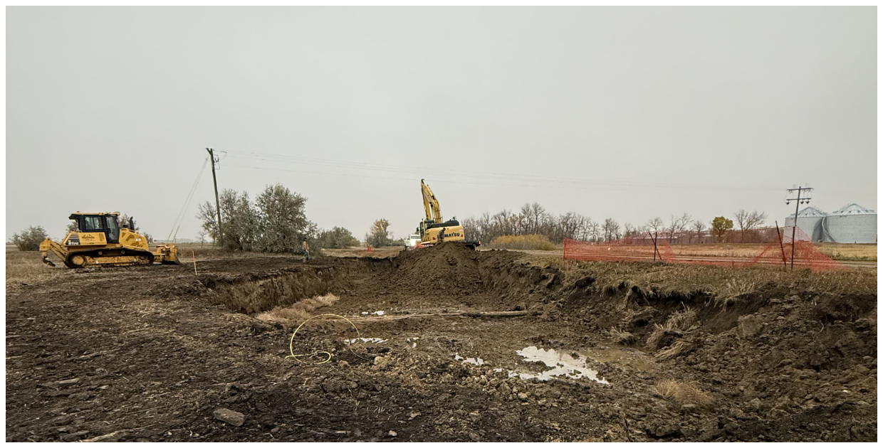 Excavators working on dirt field